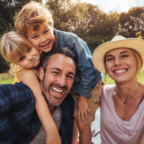family of four laughing together