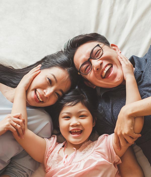 laughing family of three